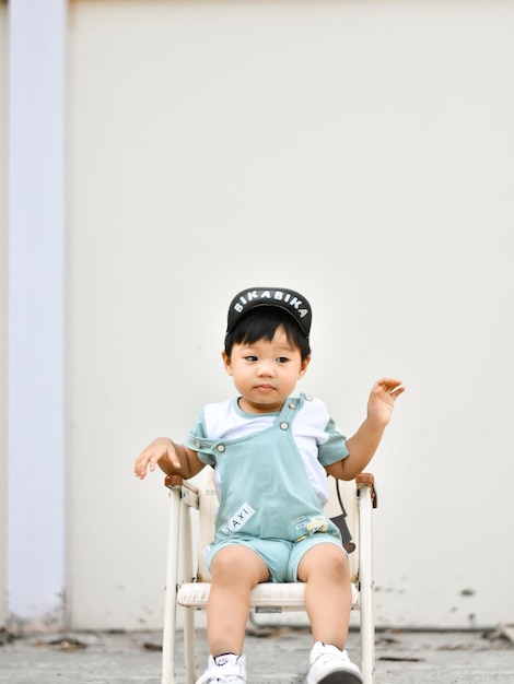 Portrait of cute boy standing against wall