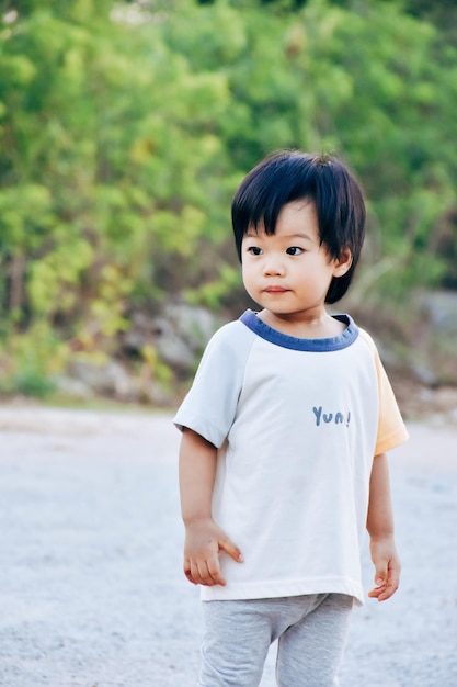 portrait of cute boy standing at park