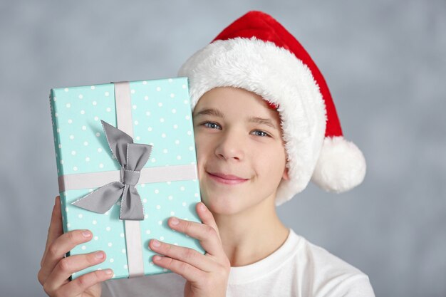 Portrait of cute boy with blue gift box, close up