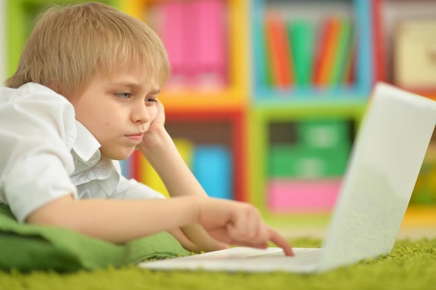 Portrait of a cute boy with a laptop