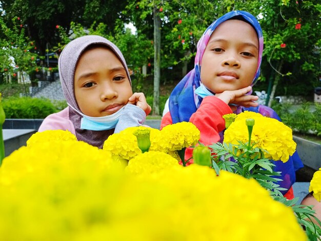 Portrait of cute boy with yellow flowers