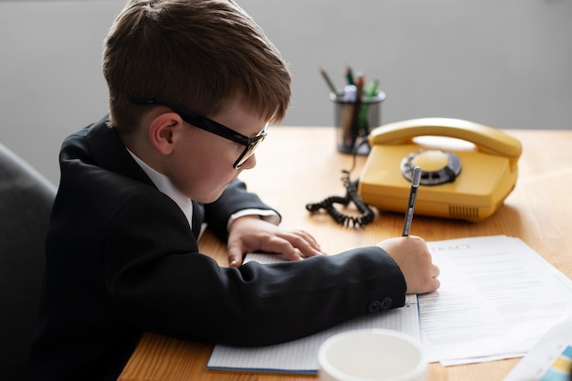 Foto ritratto di ragazzo carino che lavora alla sua scrivania in ufficio