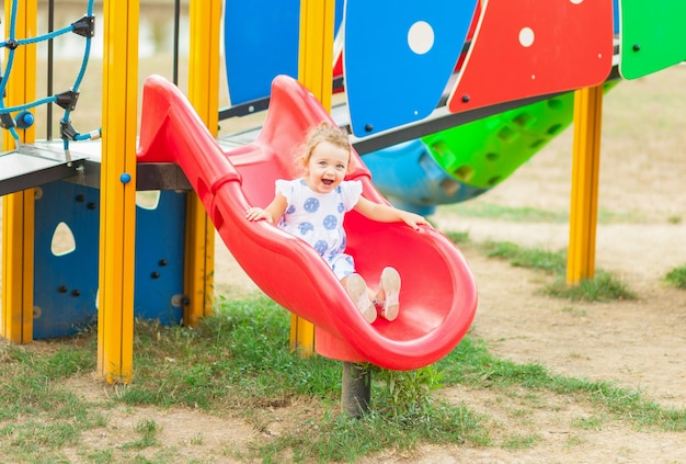 Portrait of cute cheerful girl playing at playground