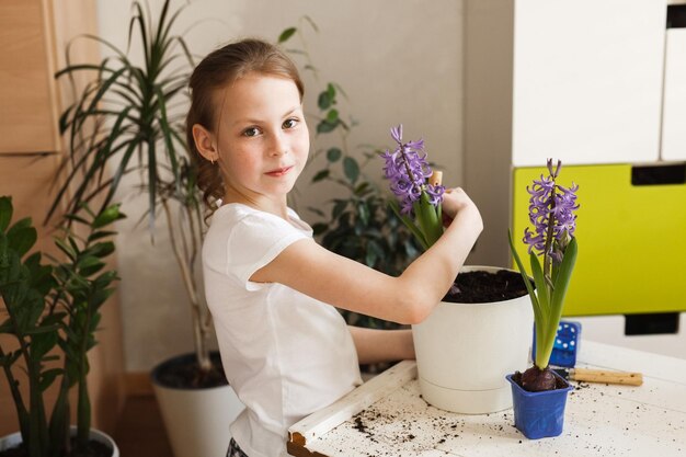 Portrait of cute child girl doing home gardening