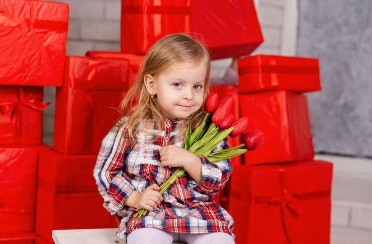 Portrait of cute child with bouquet of flowers happy birthday gift