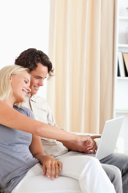 Portrait of a cute couple using a notebook