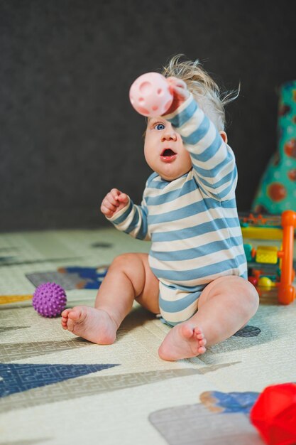 Photo portrait of a cute crawling baby boy at home