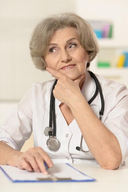 Portrait of a cute elderly woman doctor