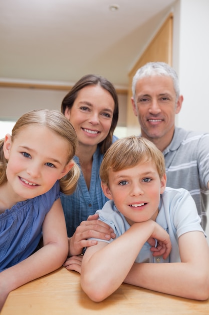 Portrait of a cute family posing in a kitchen