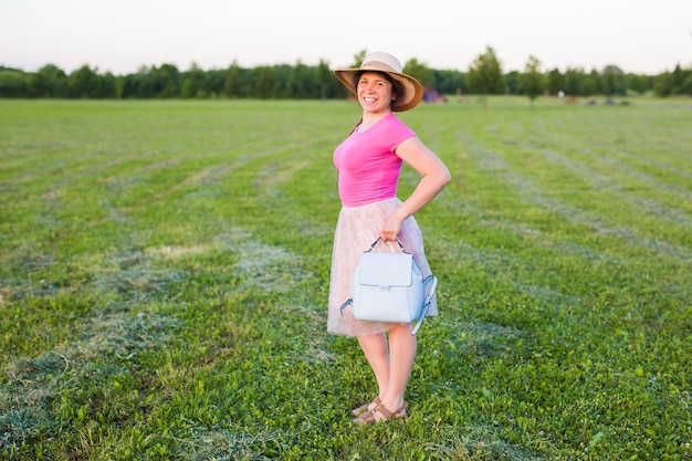 Portrait on cute funny laughing or surprised woman with backpack and hat