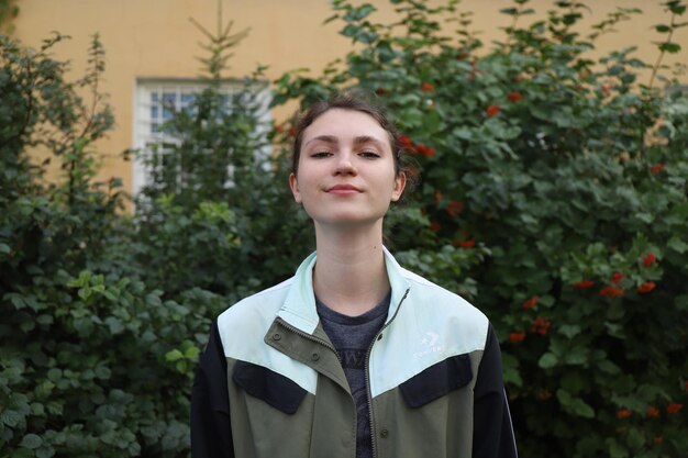 Portrait of a cute girl on a background of trees