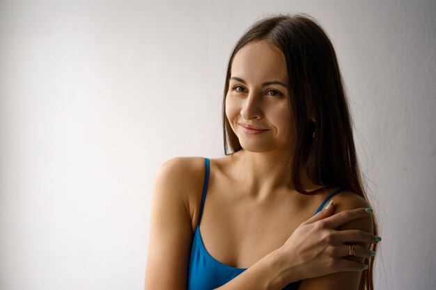 Portrait of a cute girl in a blue bodysuit smiling