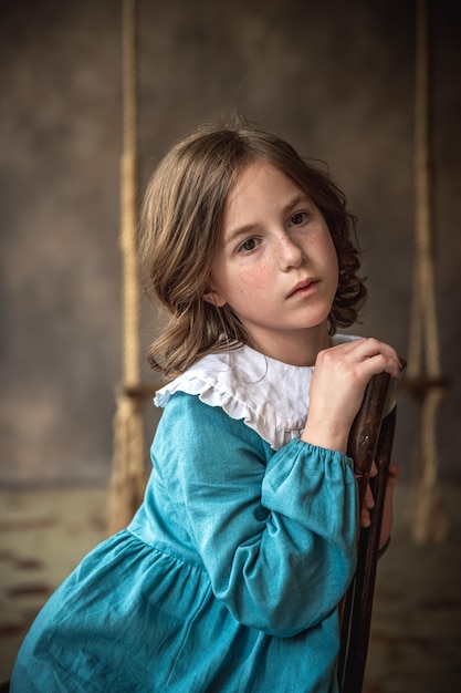 Portrait of a cute girl in blue dress