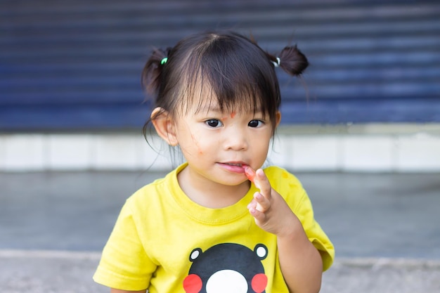 Portrait of cute girl eating food