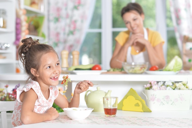 Portrait of a cute girl eating salad