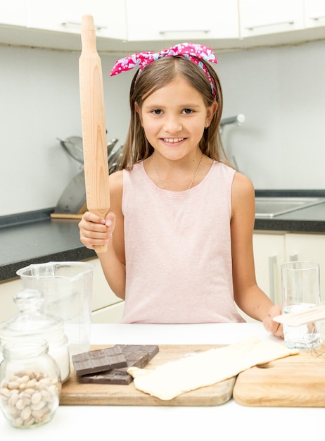 Portrait of cute girl learning culinary on kitchen at home