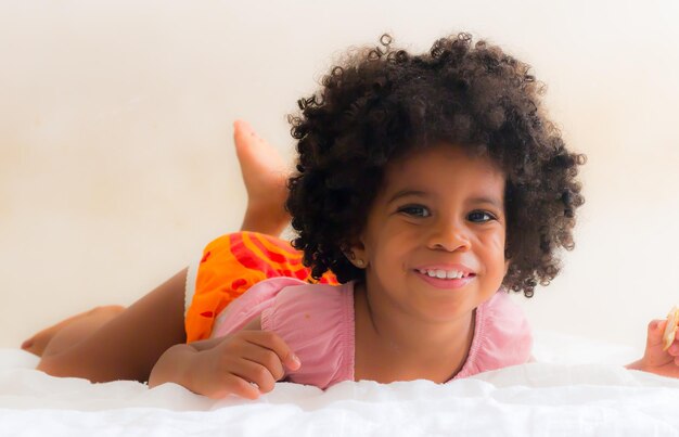 Portrait of cute girl lying on bed