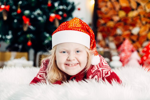 Portrait of cute girl making face while relaxing at home during christmas