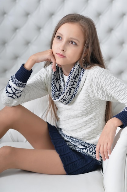 Portrait of cute girl posing on sofa