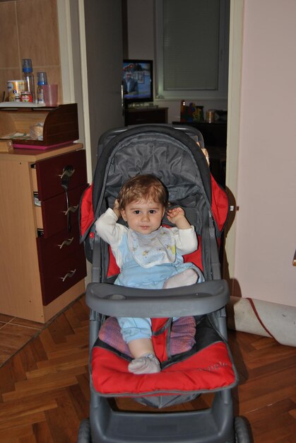 Portrait of cute girl sitting on floor at home