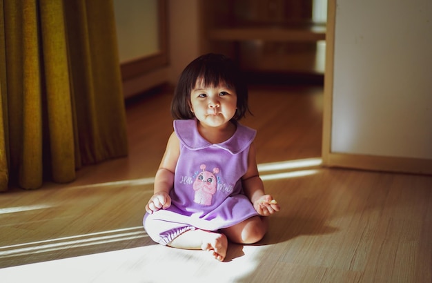 Portrait of cute girl sitting at home