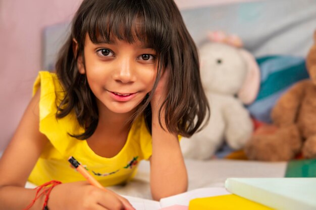 Portrait of cute girl sitting on table