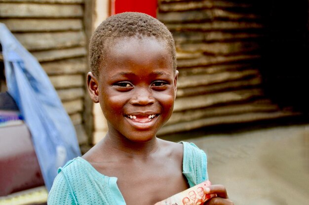 Portrait of cute girl smiling while standing outdoors