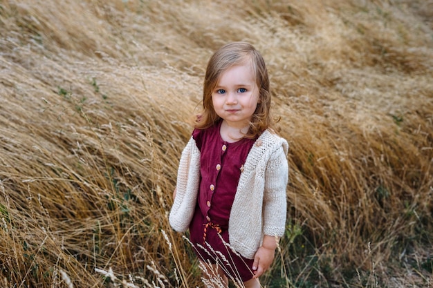 portrait of cute girl standing amidst plants
