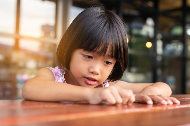 Portrait of cute girl at table