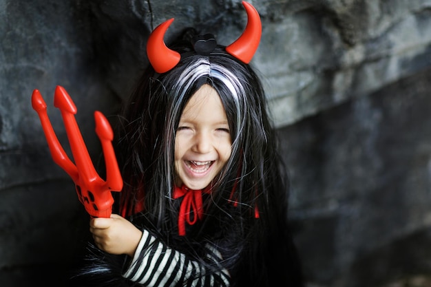 Portrait of cute girl wearing costume standing against rock formation