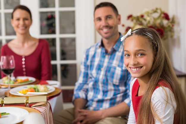 Portrait of cute girl with her parents behind