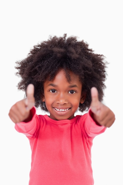 Portrait of a cute girl with the thumbs up