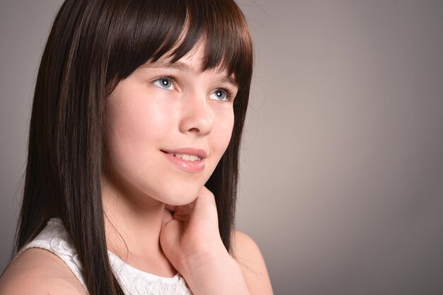 Portrait of cute happy girl with dark hair posing