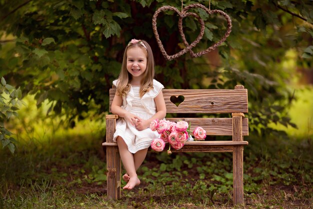 Portrait of a cute happy little girl 3-4 years old in the summer in the park.