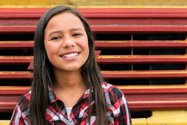 Photo portrait of cute latino girl in the street. childhood concept.