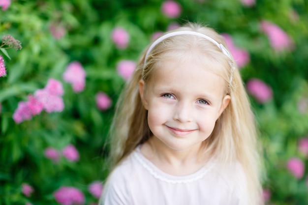 Portrait of cute little blonde girl outdoor