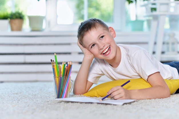 Portrait of a cute little boy drawing at home