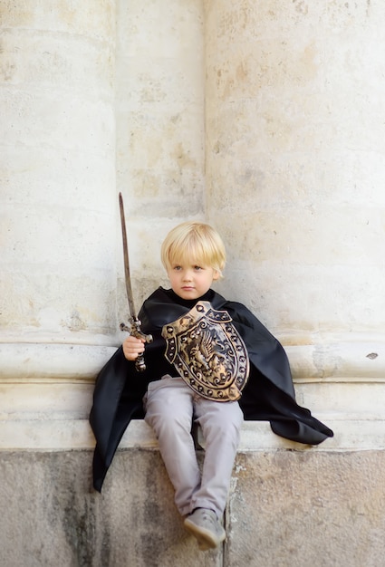 Portrait of a cute little boy dressed as a medieval knight