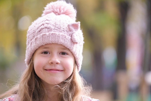 Portrait of cute little child girl in pink hat