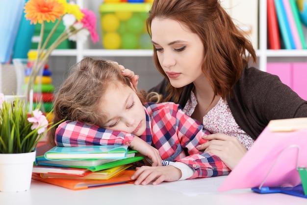 Portrait of cute little girl doing homework