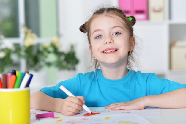 Portrait of a cute little girl drawing, close up