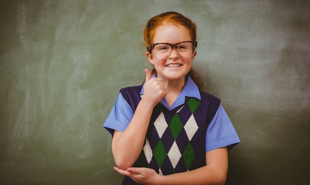 Portrait of cute little girl gesturing thumbs up