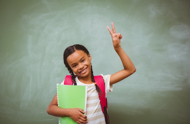 Portrait of cute little girl holding book