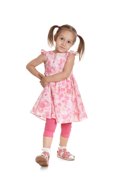 Portrait of a cute little girl in a pink dress