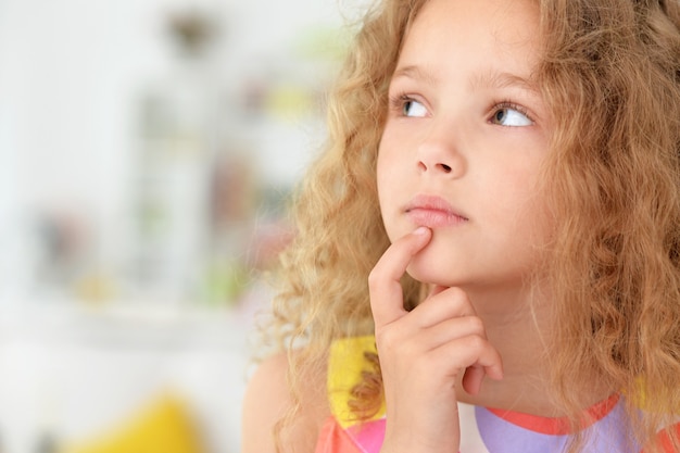 Portrait of cute little girl posing in beautiful dres