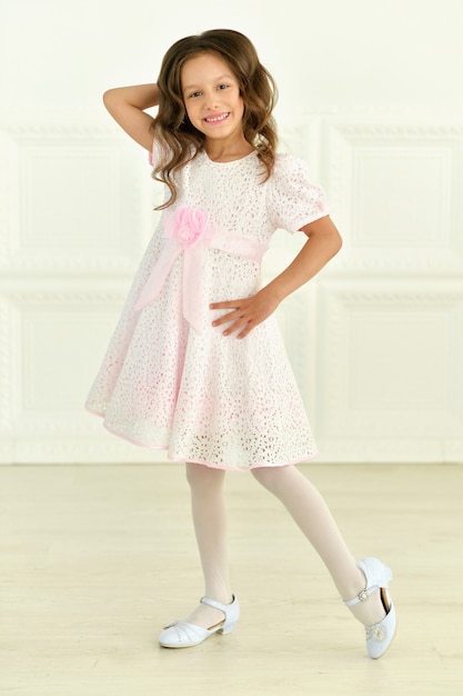 Portrait of cute little girl posing in beautiful dres