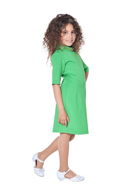 Portrait of cute little girl posing in green  dress