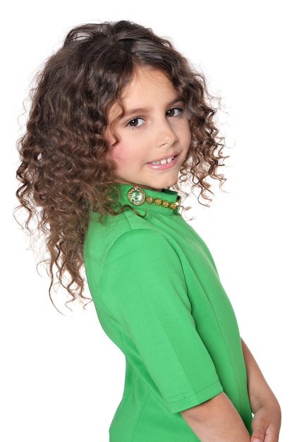 Portrait of cute little girl posing in green  dress