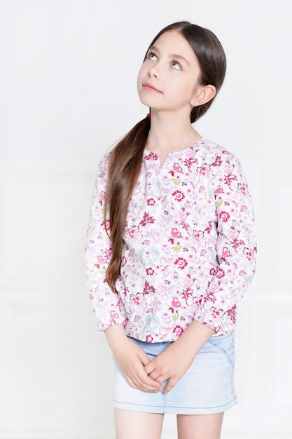 Portrait of cute little girl posing in studio