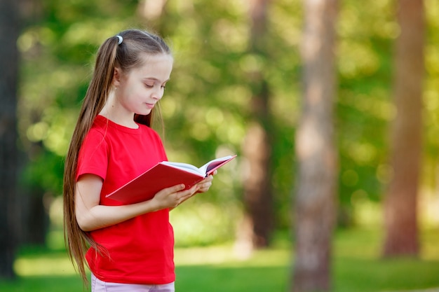 portrait of a cute little girl reading a book